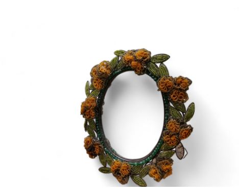 An early 20th century easel&nbsp; wirework beadwork mirror, in yellow and green, 35cm high, c.1920 