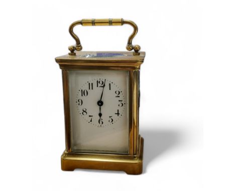 A 19th century French brass carriage clock, Arabic numerals, bevel glass panels, swing handle, 15cm high, c.1890 