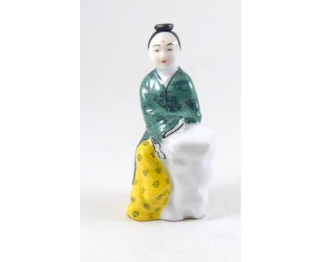 a ceramic perfume bottle in the form of a Chinese figure