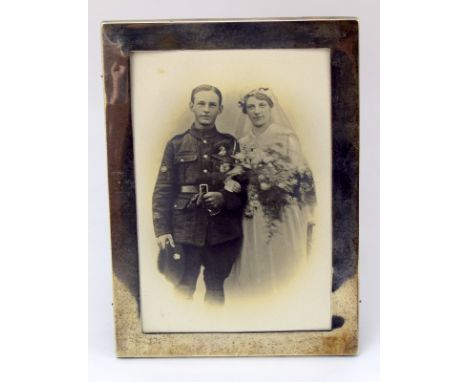 An early 20th century Mappin & Webb silver photograph frame with a WW1 Army Ordnance Corps soldiers wedding photograph 12cms 