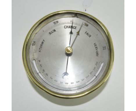A silvered dial wall barometer. 12cm diameter