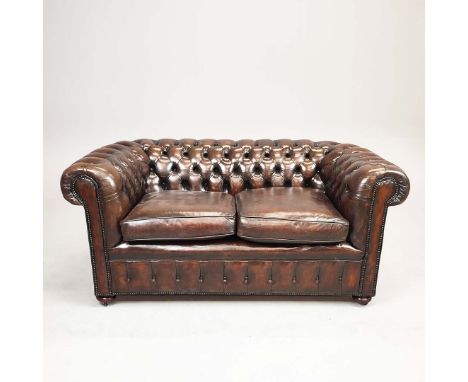 CHESTERFIELD SOFA. Brown leather on castors, 80cm H x 173cm W x 92cm D.