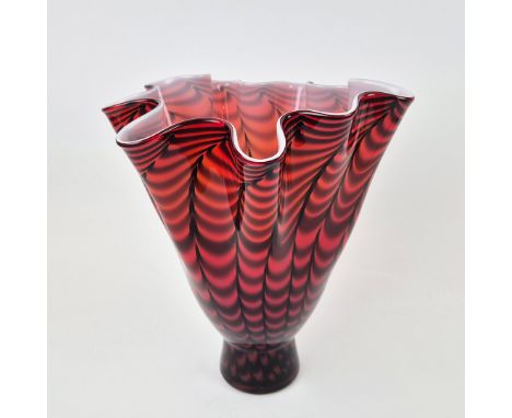 A MURANO STYLE GLASS HANDKERCHIEF VASE. opaque glass, freeform body with a red and black striped design, white interior, pont