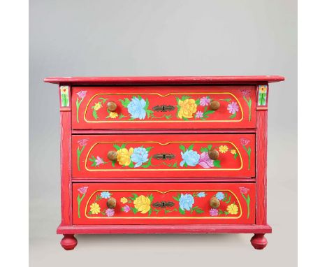 COMMODE. 19th century continental pine, with later painted floral detail and three drawers, 113cm w x 57cm d x 85cm t.