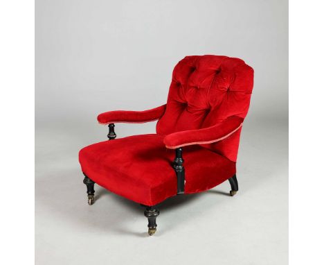 VICTORIAN EBONISED ARMCHAIR. Circa 1870, in red velvet on ceramic castors, 82cm H x 69cm W x 90cm D.