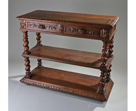 Early 20th Century oak buffet, the rectangular top above two carved frieze drawers and barley twist supports, a middle shelf,