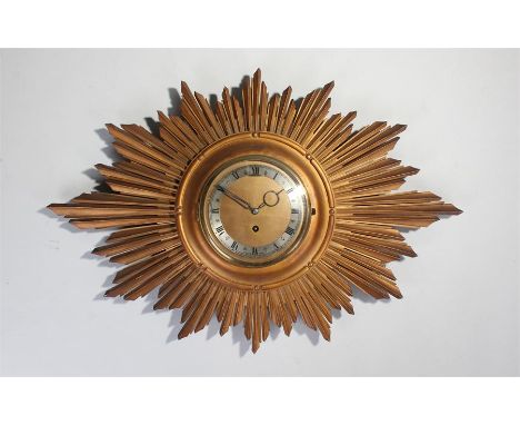 Sun burst wall clock, with a circular dial and sun burst surround