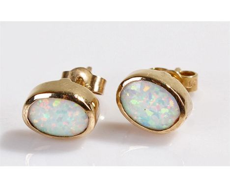 Pair of 9 carat gold opal set earrings, with oval opals set within mounts