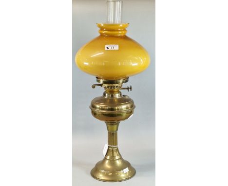 Early 20th century double oil burner lamp having mustard glass shade on a brass base. (B.P. 21% + VAT)&nbsp;&nbsp;Width if mu