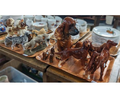 Two trays of china and other composition studies of dogs to include: Red Setters by Wade, Goebel West German seated dog etc. 