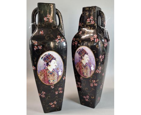 Pair of modern ceramic two handled vases on a black ground with raised enamel decoration and panels of European portraits. 40