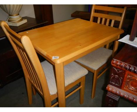 A light oak table and two chairs, COLLECT ONLY.