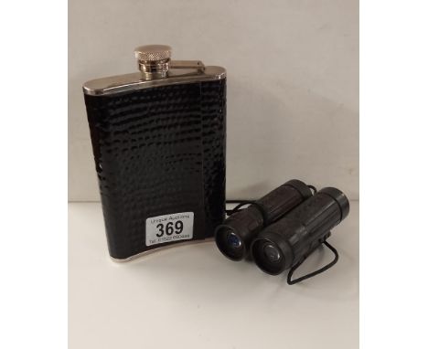 A hip flask and compact binoculars