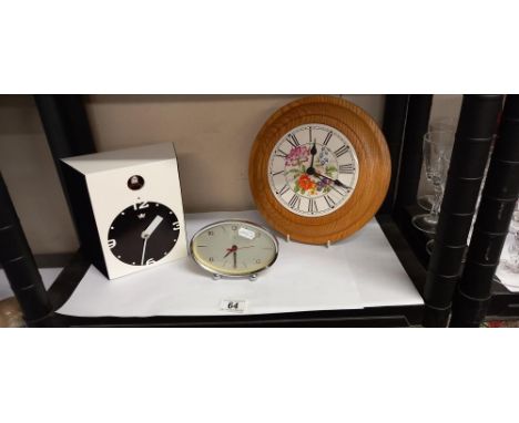 A modern cuckoo clock, wall clock and a vintage alarm clock