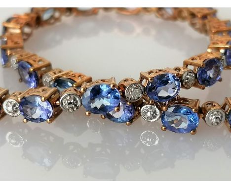 An indigo opal line or tennis bracelet, the oval stones (5 x 4mm) interspersed with diamonds, 18.5 cm, box clasp, hallmarked 