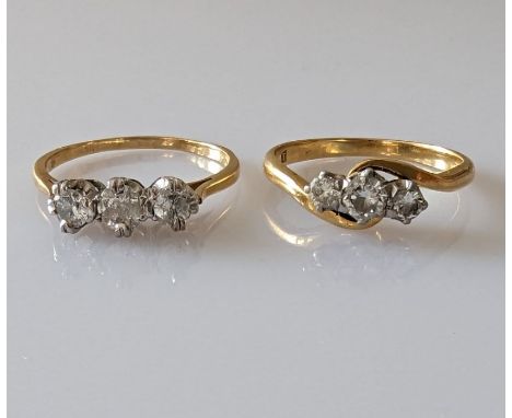 A graduated three-stone diamond ring on a yellow gold claw setting, the central stone approximately 0.25 carats flanked on ea