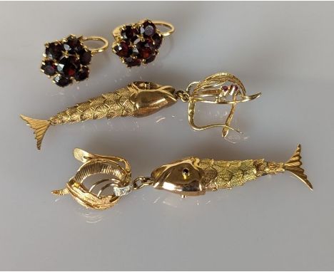 A pair of yellow gold articulated fish earrings with ruby decoration, each 60mm and a pair of garnet cluster earrings, head s