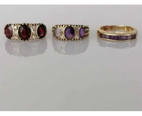 A three stone garnet gold ring; a similar amethyst ring, (stones not matching), both with carved mounts and a half-hoop etern