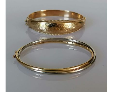 A 9ct yellow gold hinged bangle with etched floral decoration of tapering form, and another in contemporary style in 9ct whit