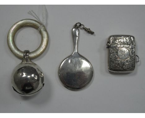 A Hallmarked Silver Bell Rattle, with Mother of Pearl teething ring, together with a miniature hallmarked silver backed hand 