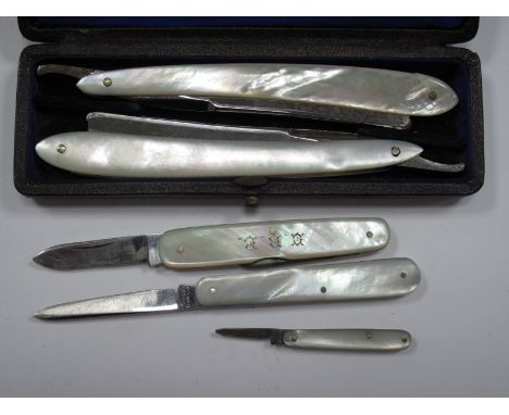 A Pair of Mother of Pearl Cutthroat Razors, in a fitted case; together with three folding pocket knives, each with mother of 