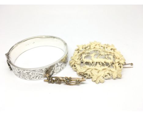 A silver bangle, a small gold brooch with floral design, a carved ivory brooch depicting deer and a vintage purse a/f.