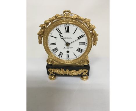 A regency style mantle clock the gilt case inset with enamel dial and Roman numerals maker tupman London 19 cm