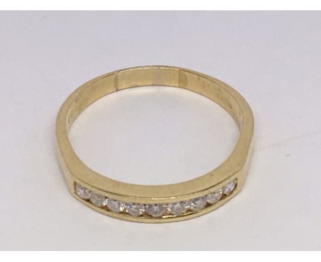 An 18ct gold diamond set half hoop ring.  Size R