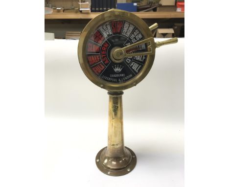 A brass ships compass, a brass ships telegraph and a Standard compass.