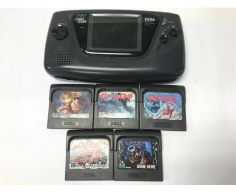 A Sega Game Gear in protective case with 5 games; Shinobi, G. Loc, Batman Returns, Ax Battler: A Legend of Golden Axe &amp; O