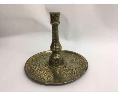 A Indo- Persian brass candlestick with detailed engraved decoration. 20 cm