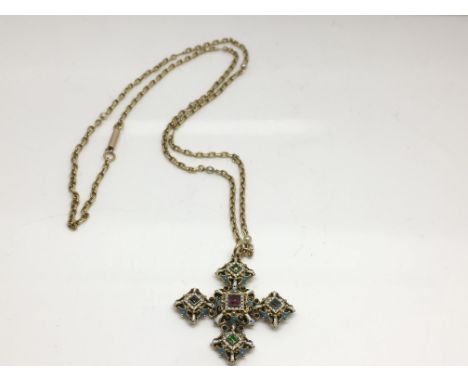 A fine quality, Gothic style gold mourning cross with blue and white enamel work inset with coloured gemstones, presented on 