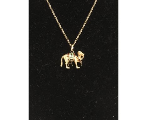 A yellow metal and enamel camel pendant on a 9ct gold chain.