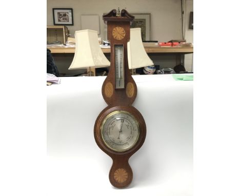 An Edwardian inlaid mahogany wall barometer.