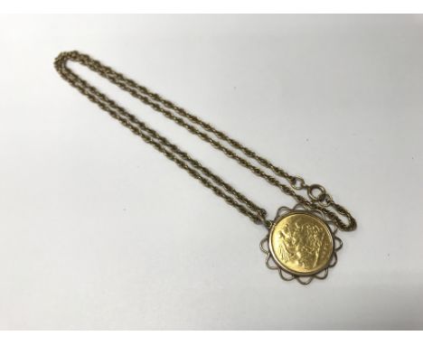 An 1897 half sovereign in a 9ct mount and chain. Weight approx 10.1g