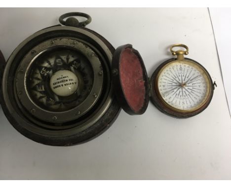 A cased John catl brass compass fitted in a leather case and a Bryer and son compass fitted in a leather case .