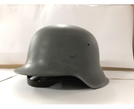 A German third Reich helmet, repainted with helmet liner. Marked 120 on the interior.