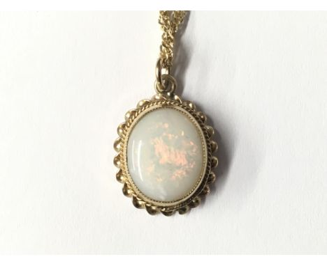 A 9ct gold oval set opal pendant and chain, total weight approx 4 grams.