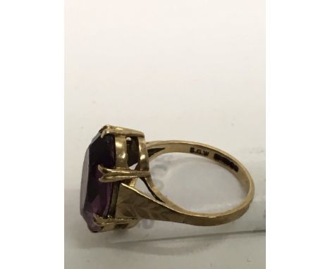 A 9ct gold ring set with an amethyst coloured stone