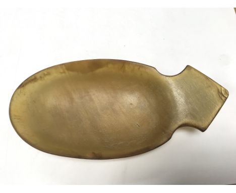 A late 19th or early 20th century carved rhino horn dish or ladle with a shaped end. Length approx 19cm