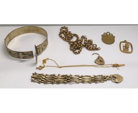 A 9ct gold gate bracelet, St.Christopher and cross and chain plus a silver gilt bangle and other yellow metal odds