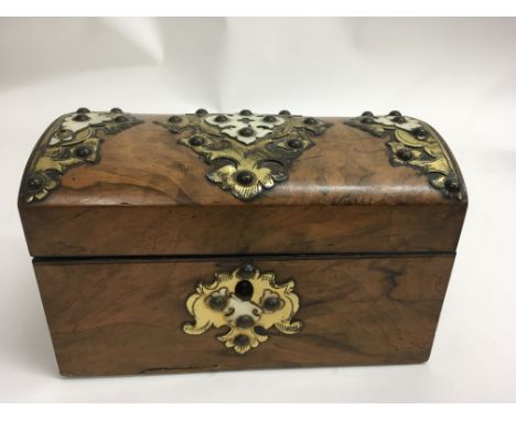 A Victorian walnut tea caddy of casket shape with brass mounts.Approx 11x20x12cm high