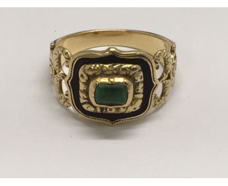 An 1823 gold mourning ring set with a square emerald in black enamel mount, engraved to band