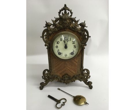 A walnut veneer Lenskirsch mantel clock with eight day movement and gilt metal mounts.Approx 31cm