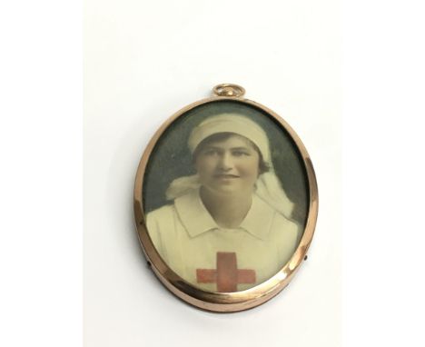 A well painted portrait miniature of WW1 nurse, mounted in yellow metal frame. Approx 7.5cm long