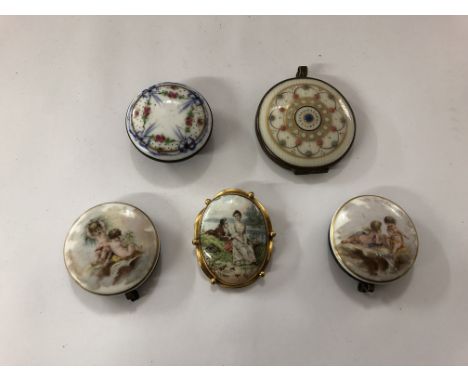 A collection of enamel items, possibly Victorian, comprising an enamel brooch and four enamel lids.