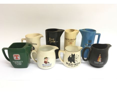 A collection of mostly breweriania decorated ceramic jugs, including a Black &amp; White scotch whisky jug, a Queen Anne scot