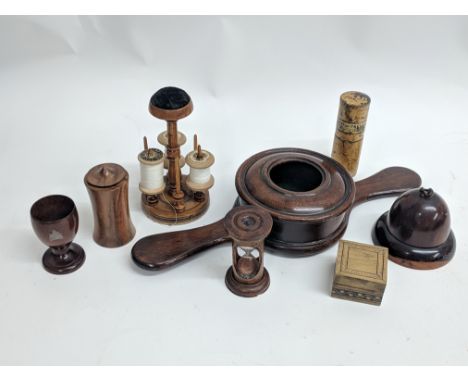 A box containing a collection of wooden treen, including string holder shaped as an acorn, egg cup with map of Tasmania (poss