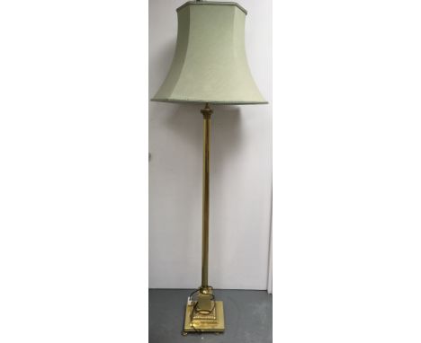 A fluted brass floor lamp and shade