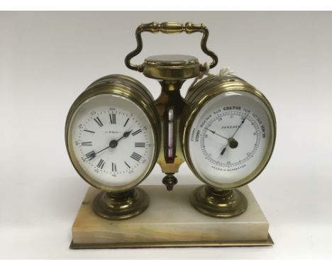 A 1930s/40s Simmone desk mantel clock with barometer, thermometer and compass in a solid brass casing. Clock has an 8 day mov